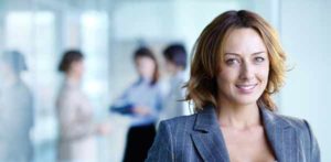 Female Business Executive Poses for Photo at Office